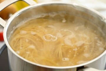 Noodles cooking in boiling, salted water.