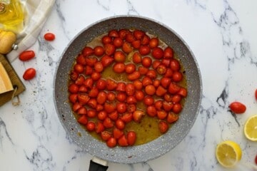 Wine and tomatoes in saute pan.