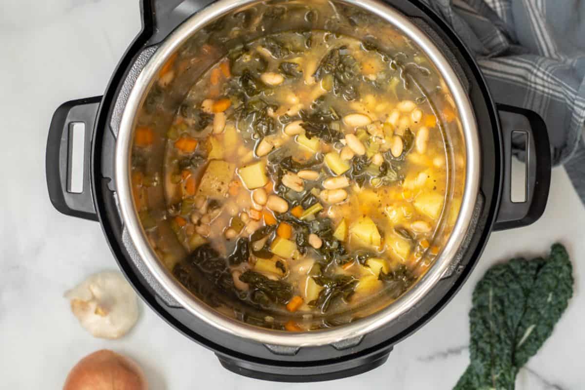 White Bean and Kale Soup in instant pot after pressure cooking.