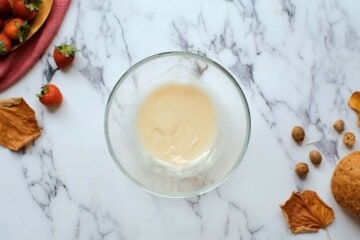 Vanilla glaze in clear mixing bowl.