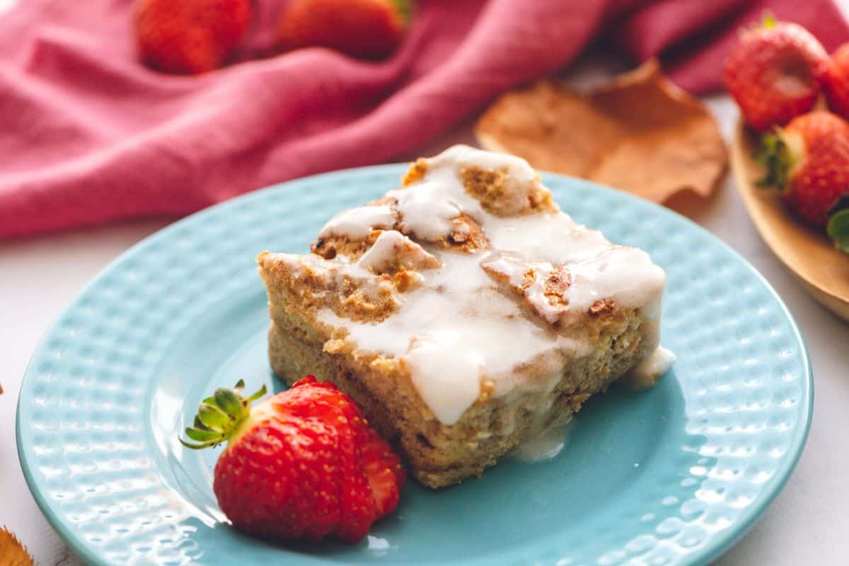 Easter Brunch Recipes Slice of French Toast Casserole on blue plate with vanilla glaze.