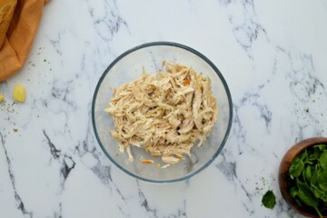 Shredded chicken after cooking it in the instant pot in large mixing bowl.