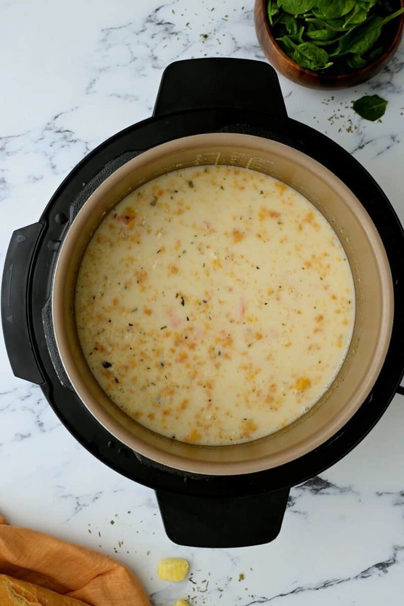 Creamy gnocchi soup inside Instant Pot before adding spinach.