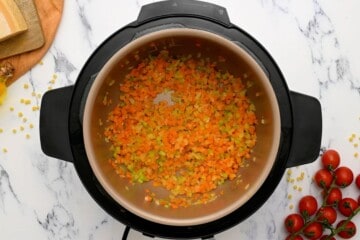 Sauteed onions, carrots, celery in inner pot of Instant Pot.
