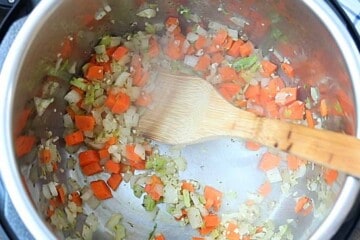 Onions, celery, and carrots sauteed in inner pot of instant pot.