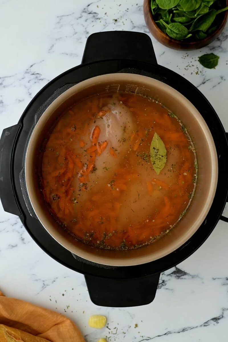 Ingredients inside inner pot of Instant Pot for chicken gnocchi soup.