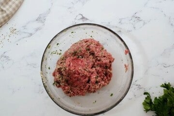 Mixing bowl with meatball mixture for baked Italian meatballs.