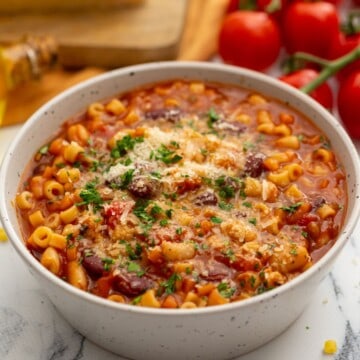 Bowl of Instant Pot pasta fagioli topped with parmesan cheese.