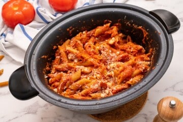 Perfectly cooked ziti in spaghetti sauce inside slow cooker.