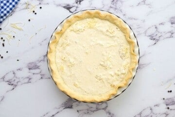 Bacon, cheese, and egg custard poured into prebaked pie crust.