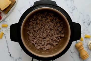 Browned Italian Sausage in inner pot after sauteing.