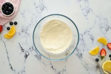 Dry ingredients for ricotta pancakes sifted together in large mixing bowl.