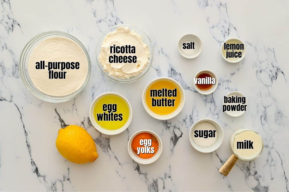 Ingredients for lemon ricotta pancakes labeled on counter.