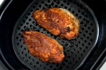 Air Fried Chicken breast with spice rub in air fryer basket.