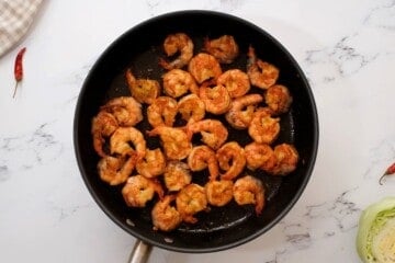 Seasoned shrimp in saute pan after being pan-fried.