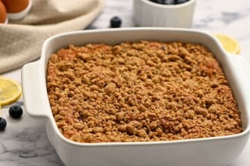 Baked Blueberry Coffee Cake with streusel in white baking dish.