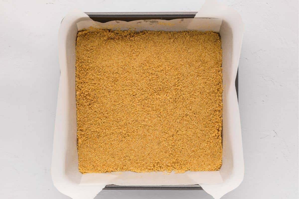 Graham cracker crust pressed into 8x8 baking pan lined with parchment paper.