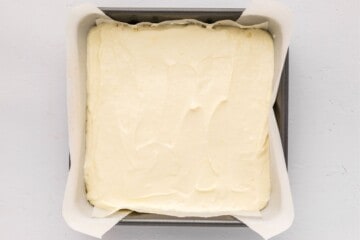 Cream cheese lemon batter spread evenly over graham cracker crust before baking.