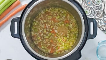 Sauteed aromatics in inner pot after being deglazed inside the inner pot.