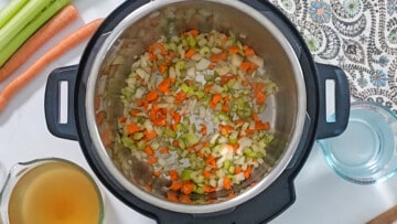 Sauteed carrots, onions, and celery inside inner pot.