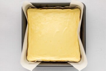 Baked lemon cheesecake bars in 8x8 baking dish after baking bars.