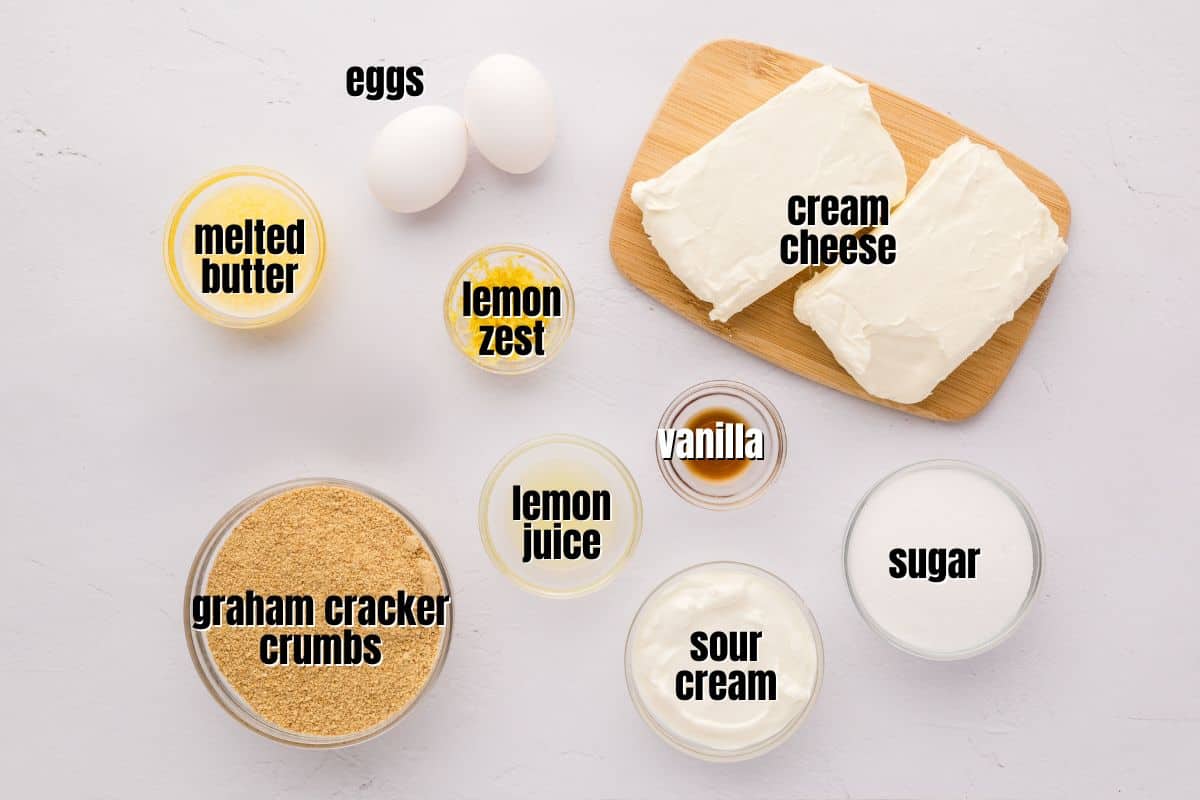 Ingredients for lemon cheesecake bars labeled on counter.