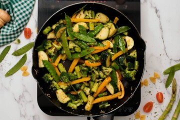 Asparagus, zucchini, peppers, and broccoli sauteed in skillet with olive oil.