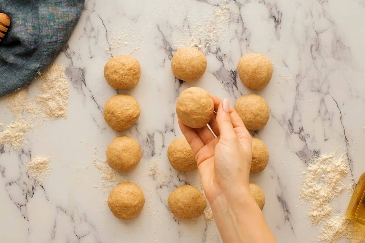 12 dough balls formed from whole wheat dough recipe.
