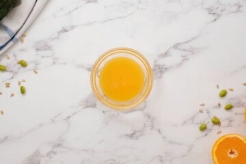 Citrus orange dressing for broccoli salad in small mixing bowl.