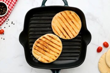 Pitas being toasted on grill plate.