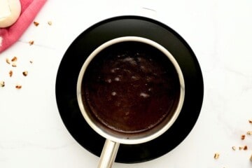 Butter, cocoa powder, and milk combined in small saucepan for cocoa frosting.