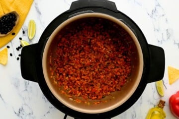 Carrots, jalapenos, onions, and peppers sauteed in inner pot with cumin and paprika.