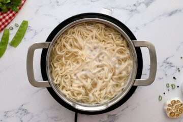 Lo Mein Noodles being cooked in pan.