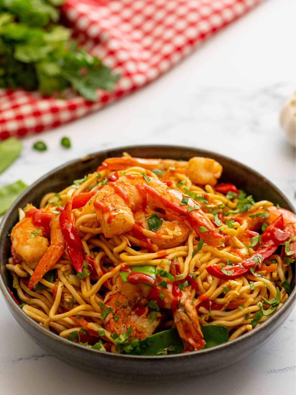 Shrimp Lo Mein in bowl topped with fresh cilantro.