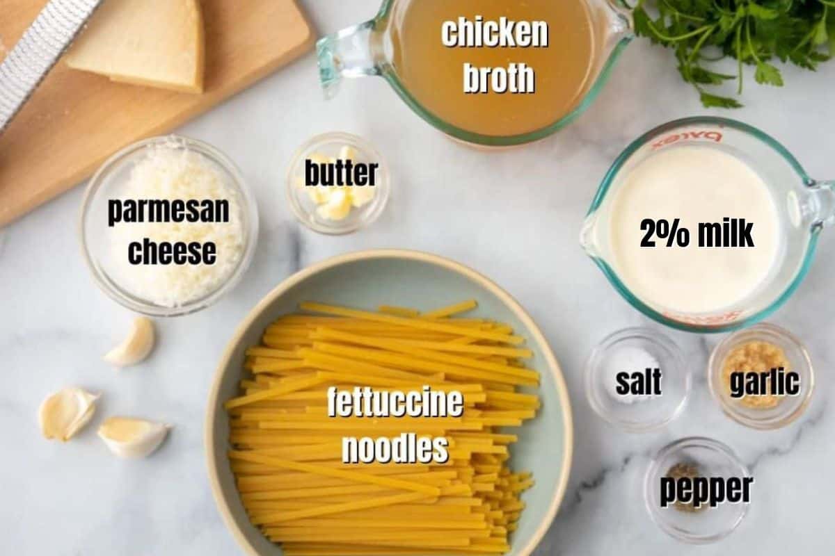 Ingredients for fettucine with light alfredo sauce labeled on counter.