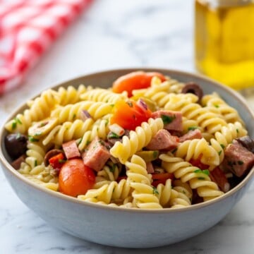Bowl of noodles cooked with antipasto toppings.