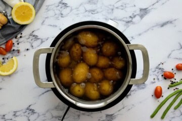 Baby new potatoes in large pan covered with water.