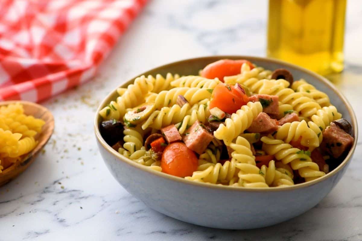 Close up of Antipasto Pasta Salad with tomatoes, onions, and pepperoni.