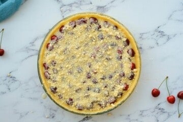 Assembled cherry crumble pie in 9-inch pie pan before baking.