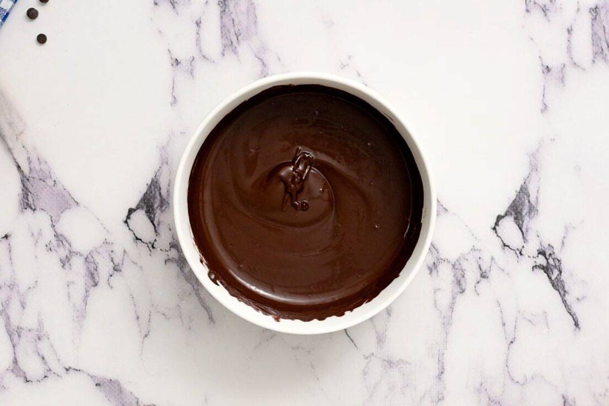 Melted chocolate in white bowl.