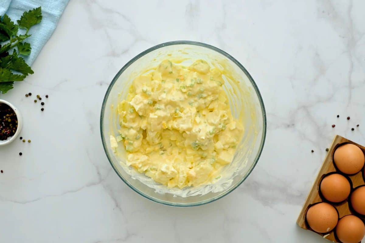 Potatoes, hard-boiled eggs, celery, and onions mixed into mayonnaise based dressing.