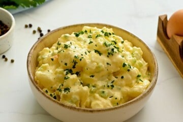 Hellmann's Potato Salad in large serving bowl topped with fresh parsley.