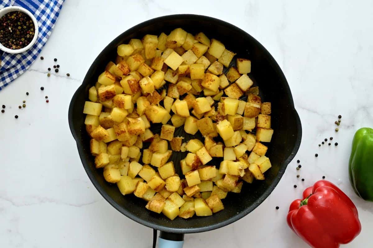 Pan-fried cubed potatoes in large saute pan.