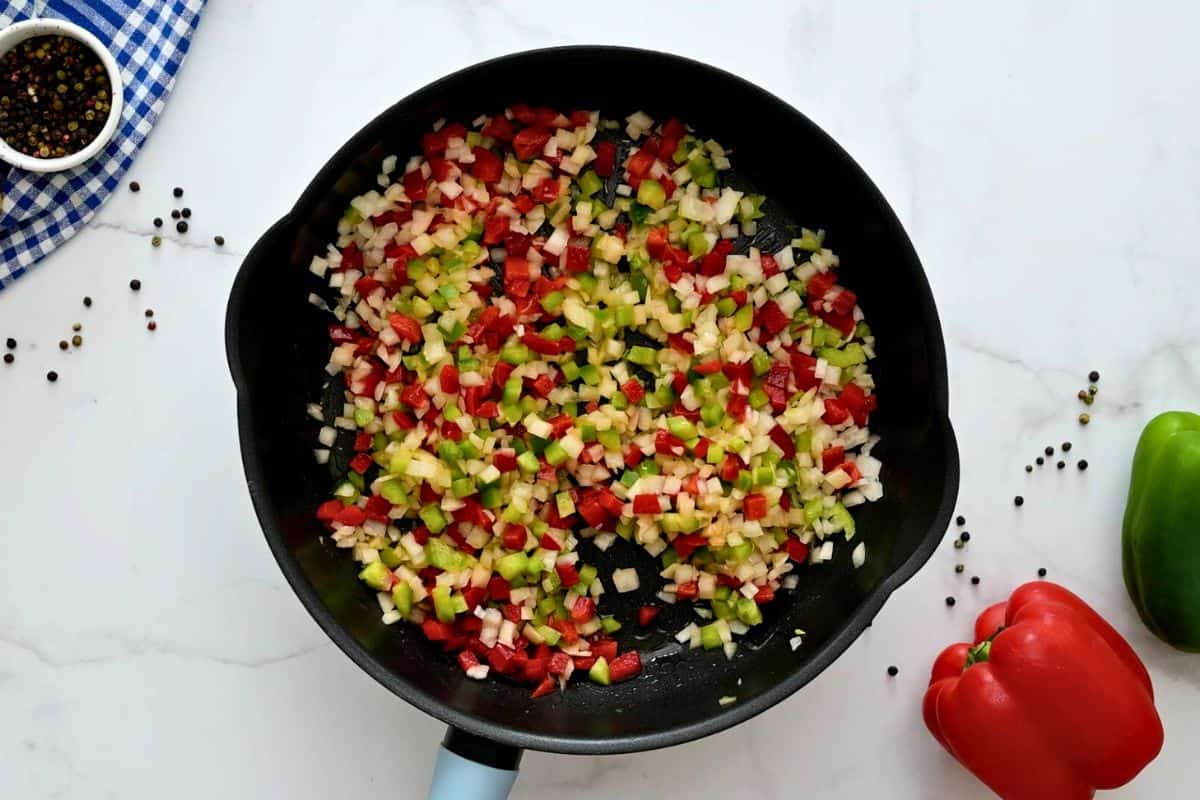 Peppers and onions sauteed in large saute pan.