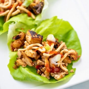Lettuce Cup filled with tofu vegetarian filling and topped with chow mein noodles and hot sauce.