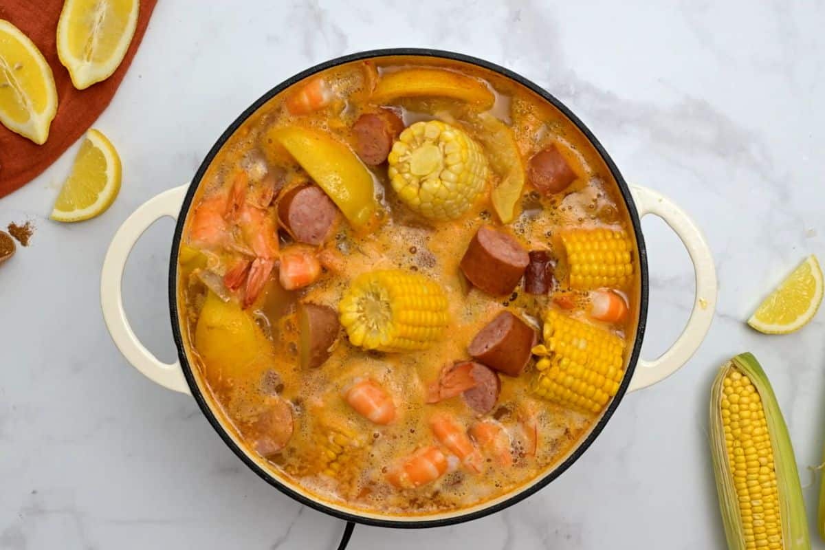 Shrimp, corn, potatoes, onions, garlic, and sausage boiling in large pot with old bay and beer.