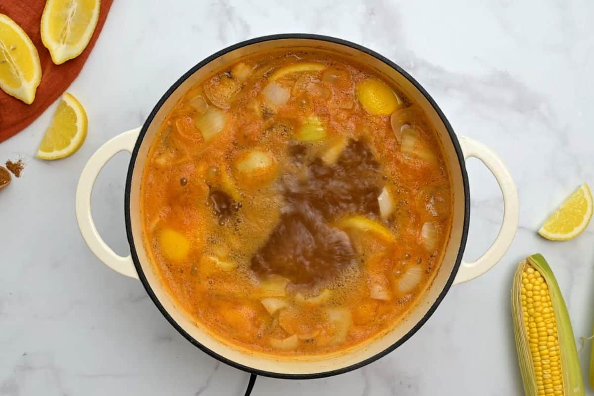 Water seasoned with old bay boiling in large stock pot.