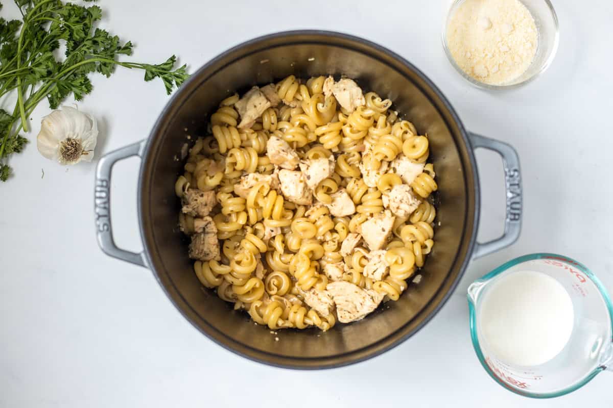 Tender pasta and chicken in stock pan before adding cream and parmesan. 