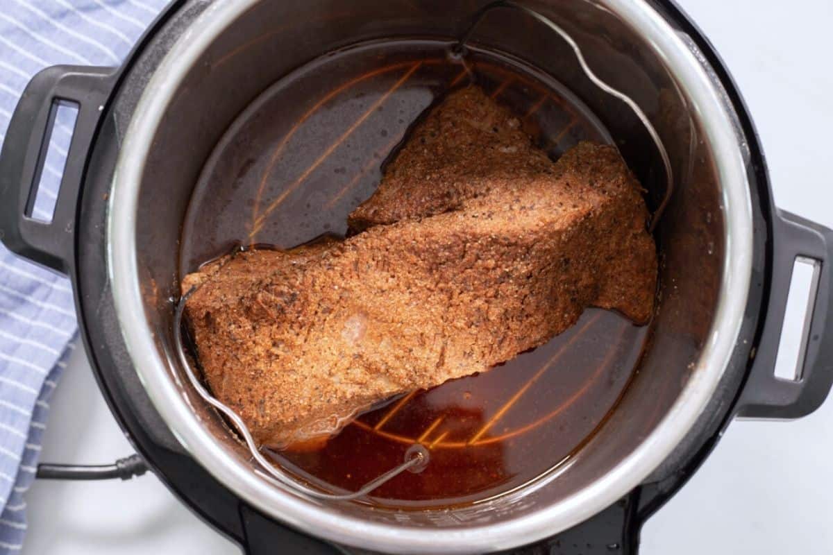 Pressure Cooked Brisket inside inner pot on metal trivet.