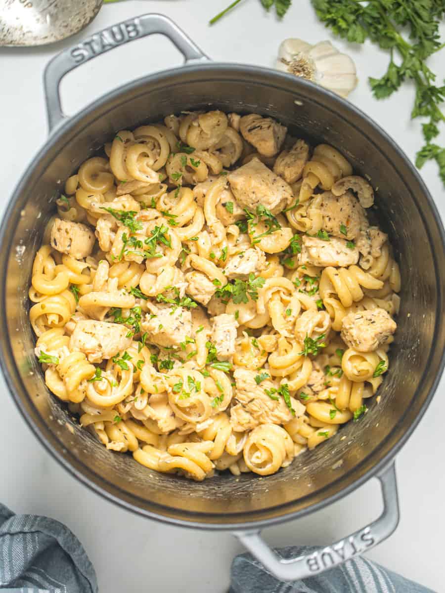 Creamy Parmesan Chicken Pasta in large stock pan topped with parsley.